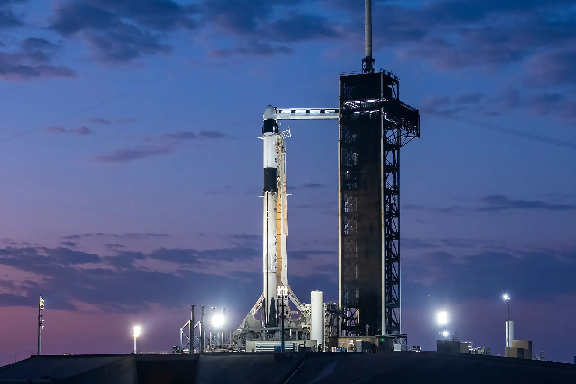 A SpaceX Falcon 9 rocket with the company’s Dragon spacecraft on top on the launch pad.