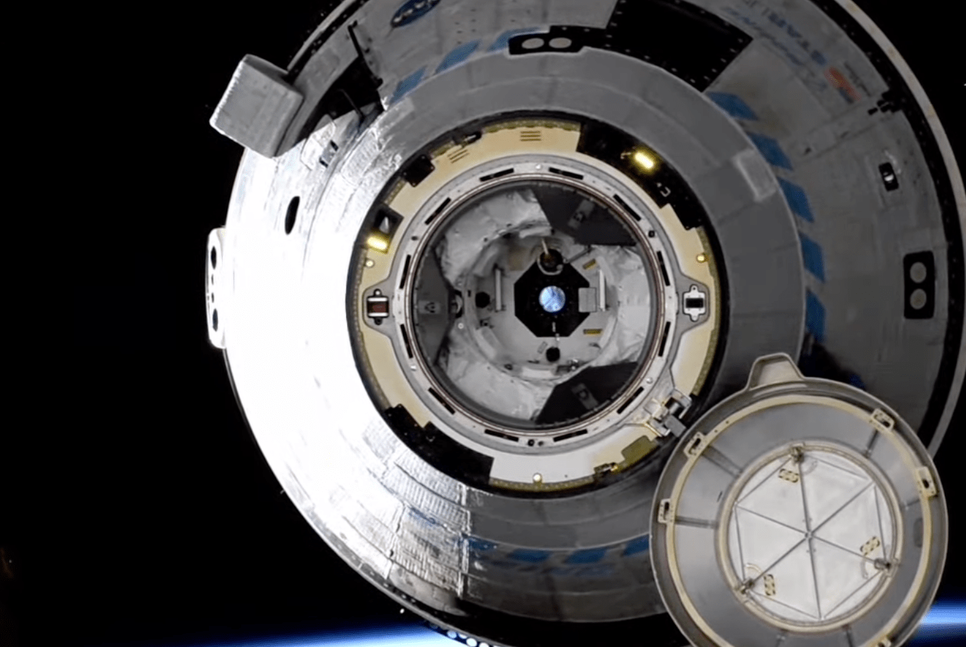 A picture of Starliner taken as it slowly floats away from the International Space Station just after undocking.